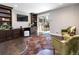 A stylish living room with hardwood floors, custom built-ins, and a sliding door to the outdoor area at 2601 S Quebec St # 6, Denver, CO 80231