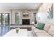Cozy living room featuring a stone fireplace, natural light, and comfortable seating, perfect for relaxation at 2601 S Quebec St # 6, Denver, CO 80231