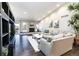 Bright and airy living room with hardwood floors, a stone fireplace, and comfortable seating at 2601 S Quebec St # 6, Denver, CO 80231