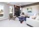 Bright living room with fireplace, comfortable seating, and large windows at 2601 S Quebec St # 6, Denver, CO 80231