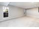 Spacious, light-filled living room featuring neutral carpet, paint and large windows at 2601 S Quebec St # 6, Denver, CO 80231
