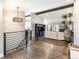 Open-concept living room with modern lighting and hardwood floors connects seamlessly to the kitchen at 2601 S Quebec St # 6, Denver, CO 80231