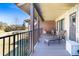 A cozy covered patio furnished with a chaise lounge, chairs, and tables overlooking the property at 2601 S Quebec St # 6, Denver, CO 80231