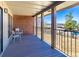 A covered patio with stylish furniture and a view of the expansive yard and neighboring rooftops at 2601 S Quebec St # 6, Denver, CO 80231