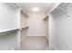 Bright walk-in closet with carpet, storage shelves, and rods at 2601 S Quebec St # 6, Denver, CO 80231