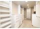 A spacious walk-in closet with custom shelving, drawers, and ample storage space at 2601 S Quebec St # 6, Denver, CO 80231