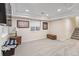 Finished basement with neutral walls, carpet, recessed lights, trunk, and staircase to the main floor at 8335 Deframe Ct, Arvada, CO 80005