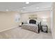 Finished basement area with neutral walls, carpet, recessed lights and a day bed at 8335 Deframe Ct, Arvada, CO 80005