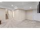 Finished basement area with neutral walls, carpet, recessed lights and a staircase at 8335 Deframe Ct, Arvada, CO 80005