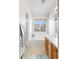 Bright bathroom featuring a soaking tub beneath a window and a light wood vanity at 8335 Deframe Ct, Arvada, CO 80005