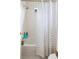 Bathroom with a white tiled tub/shower combination with a patterned shower curtain at 8335 Deframe Ct, Arvada, CO 80005