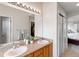 Bathroom featuring double sinks, neutral decor, and ample counter space at 8335 Deframe Ct, Arvada, CO 80005