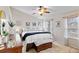 Bright bedroom with a large bed, neutral decor, and a ceiling fan at 8335 Deframe Ct, Arvada, CO 80005