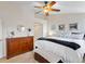 Bright bedroom featuring a dresser, ceiling fan, and a large bed at 8335 Deframe Ct, Arvada, CO 80005