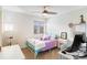 Bright bedroom with a colorful bed, desk, and ample natural light at 8335 Deframe Ct, Arvada, CO 80005