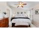 Bright bedroom with a large bed, neutral decor, and a ceiling fan at 8335 Deframe Ct, Arvada, CO 80005