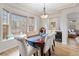 Dining room with large window, table with seating for six, and decorative light fixture at 8335 Deframe Ct, Arvada, CO 80005