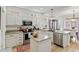 Well lit kitchen with granite counters, stainless appliances, and white cabinets at 8335 Deframe Ct, Arvada, CO 80005