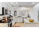 Bright kitchen with stainless steel appliances, granite countertops and a view to the living room at 8335 Deframe Ct, Arvada, CO 80005