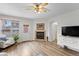 Cozy living room with lots of natural light and a corner fireplace at 8335 Deframe Ct, Arvada, CO 80005