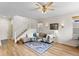 Spacious living room with stairs, featuring a ceiling fan and hardwood floors at 8335 Deframe Ct, Arvada, CO 80005