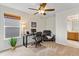 Well-lit home office featuring a work space, comfortable seating, and a ceiling fan at 8335 Deframe Ct, Arvada, CO 80005