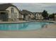 Outdoor community pool with lounge chairs and manicured landscaping at 3271 E 103Rd Pl # 1307, Thornton, CO 80229