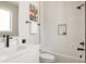 Bright bathroom with a white vanity, black fixtures, a modern bathtub, and decorative artwork at 8280 E 36Th Ave # 26, Denver, CO 80238