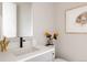 Chic powder room with stylish sink, white walls, artwork, and modern fixtures at 8280 E 36Th Ave # 26, Denver, CO 80238