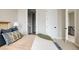 Bright bedroom showing the doorway to the bathroom and stairs with metal railings at 8280 E 36Th Ave # 26, Denver, CO 80238