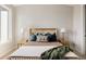 Stylish bedroom featuring a comfortable bed with decorative pillows and side tables with lamps at 8280 E 36Th Ave # 26, Denver, CO 80238