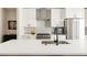 Modern kitchen with stainless steel appliances, white cabinets, and a large kitchen island at 8280 E 36Th Ave # 26, Denver, CO 80238
