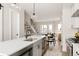 Open floorplan kitchen with stainless steel appliances, white cabinets, island and hardwood flooring at 8280 E 36Th Ave # 26, Denver, CO 80238