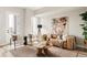 Cozy living room with stylish seating, a large rug, and a rustic coffee table at 8280 E 36Th Ave # 26, Denver, CO 80238