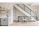 Staircase with carpet and modern black railings, in view of a stylish bar area at 8280 E 36Th Ave # 26, Denver, CO 80238