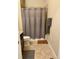 A full bathroom featuring tile flooring and a shower with gray accents and fixtures at 12604 Madison Way, Thornton, CO 80241