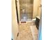 Bathroom with glass-enclosed shower, vanity, and tile flooring at 12604 Madison Way, Thornton, CO 80241