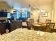 Open dining area with hardwood floors and stylish chandelier, flowing into the living space at 12604 Madison Way, Thornton, CO 80241