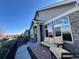 Inviting home exterior with a charming front porch and attractive stone accents, enhanced by a seating area at 12604 Madison Way, Thornton, CO 80241