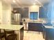 Modern kitchen with stainless steel appliances, granite countertops, and ample cabinet space at 12604 Madison Way, Thornton, CO 80241