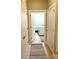 Hallway view of the laundry room features a modern washing machine, dryer, and storage at 12604 Madison Way, Thornton, CO 80241