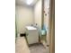 Bright laundry room featuring a washing machine, dryer, and storage at 12604 Madison Way, Thornton, CO 80241