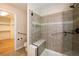 Main bathroom with walk-in shower, glass enclosure, and tiled walls at 8182 S Winnipeg Ct, Aurora, CO 80016