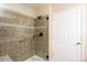 Bathroom with tiled shower, glass door, and grab bar at 8182 S Winnipeg Ct, Aurora, CO 80016