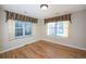 Bedroom with wood floors and two large windows at 8182 S Winnipeg Ct, Aurora, CO 80016