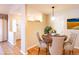 Virtually staged dining area with round table and four chairs at 8182 S Winnipeg Ct, Aurora, CO 80016