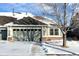 Charming house exterior with a two-car garage and snow-covered landscaping at 8182 S Winnipeg Ct, Aurora, CO 80016