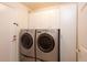 Bright laundry room with modern washer and dryer, and extra storage at 8182 S Winnipeg Ct, Aurora, CO 80016