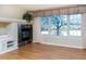 Spacious living room with a fireplace and large windows at 8182 S Winnipeg Ct, Aurora, CO 80016