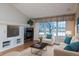 Bright living room with fireplace and large windows at 8182 S Winnipeg Ct, Aurora, CO 80016